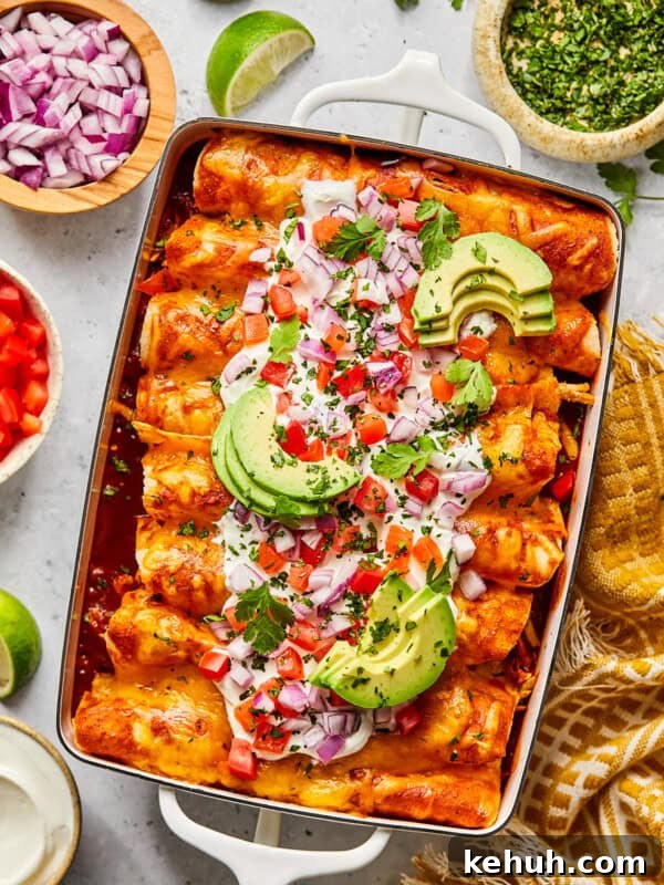 Chicken and black bean enchiladas with toppings in a casserole dish
