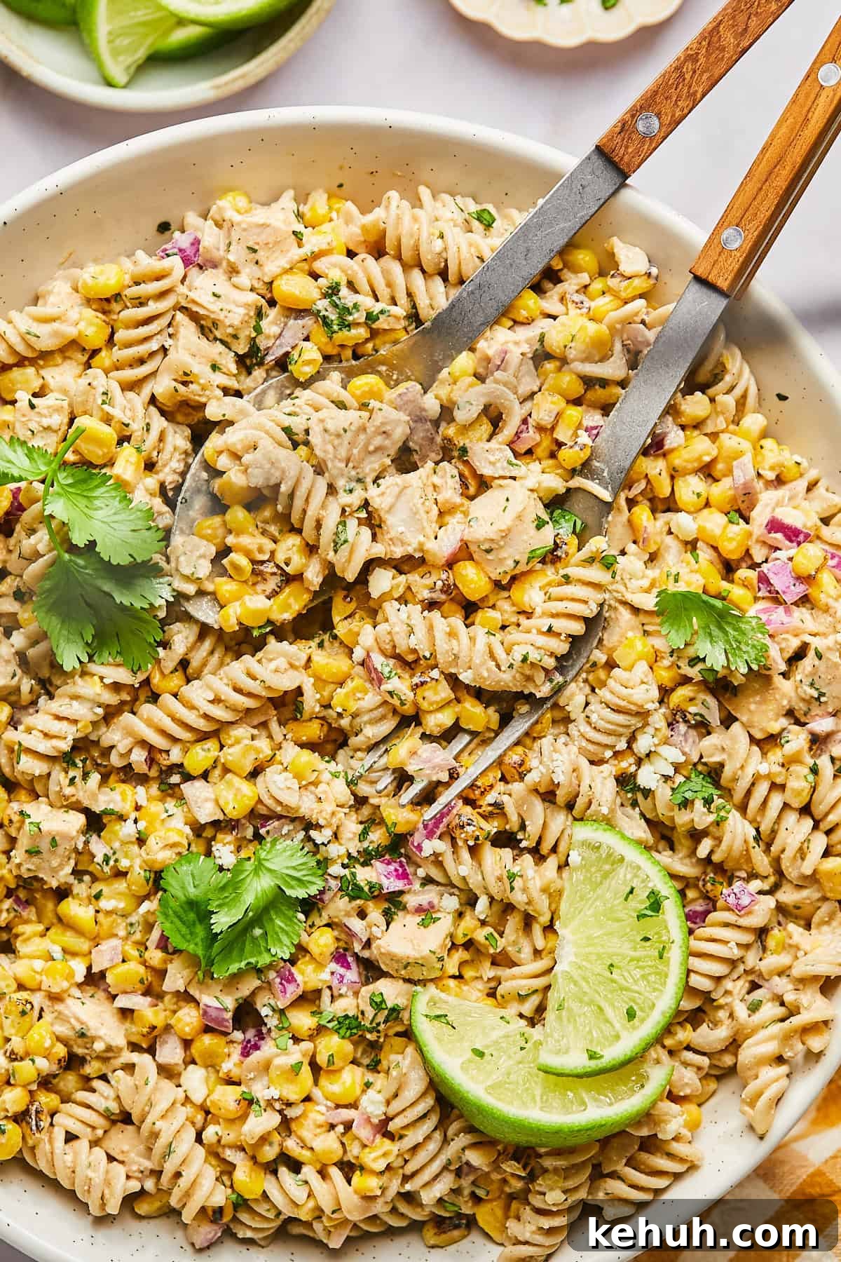street corn pasta salad with tongs