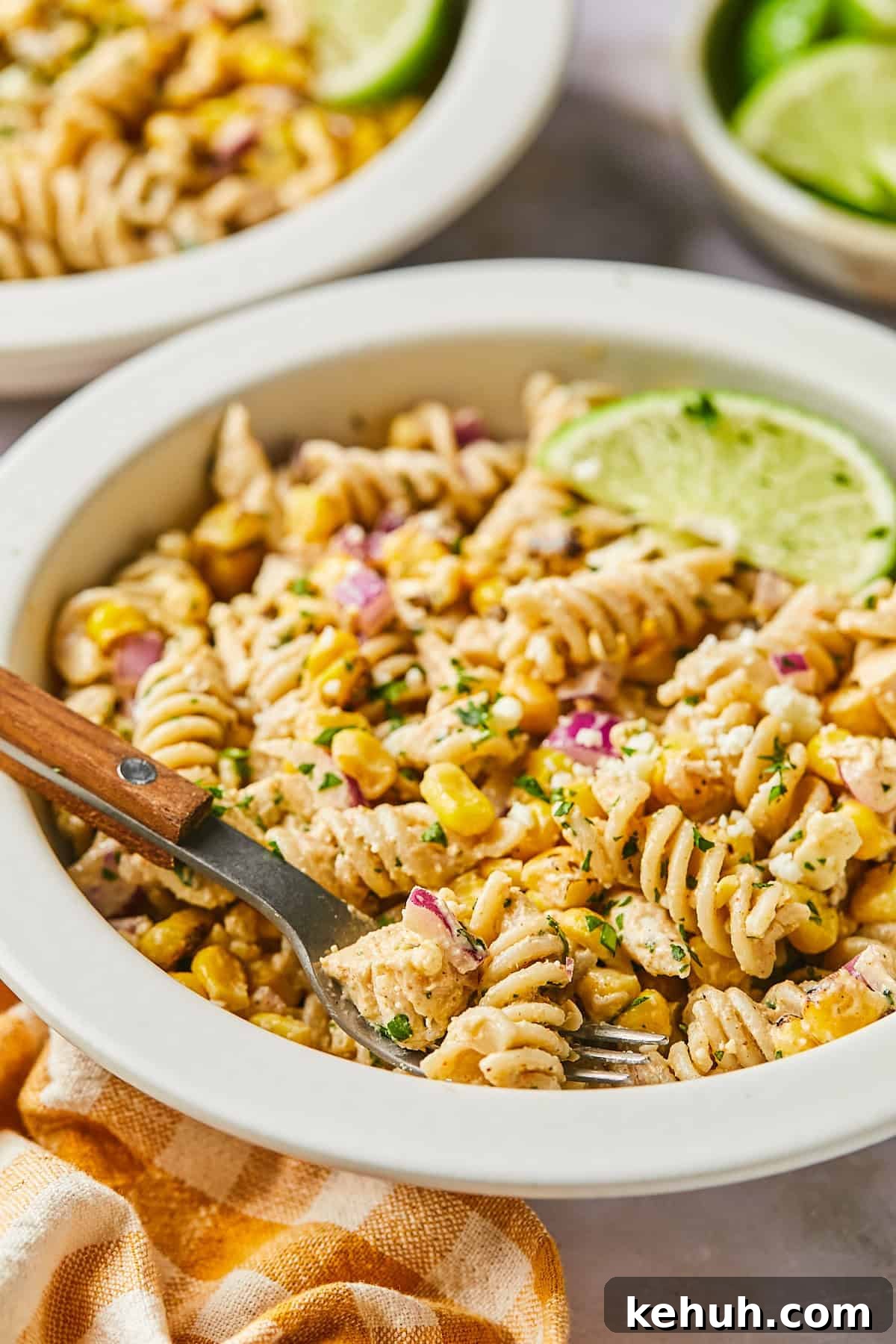 side view of Mexican street corn pasta salad in a white bowl