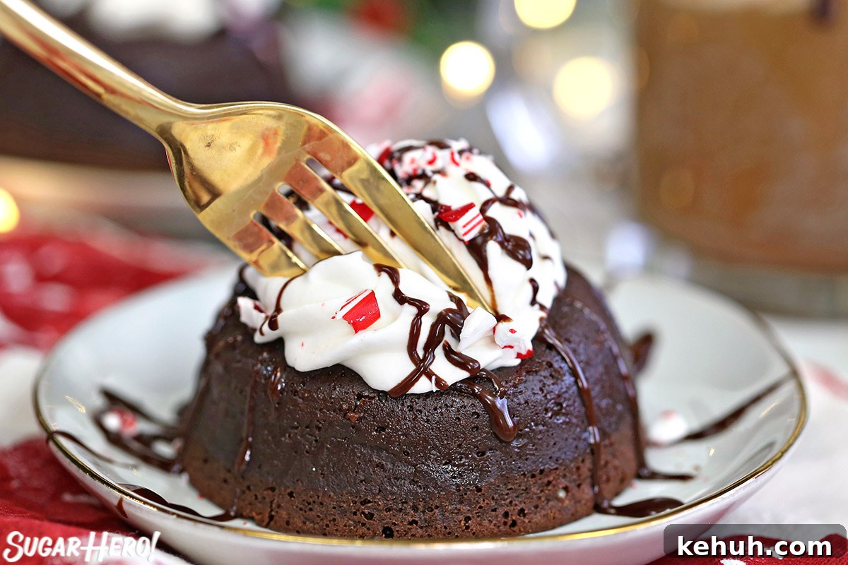 Gold fork taking a bite out of Peppermint Lava Cake.