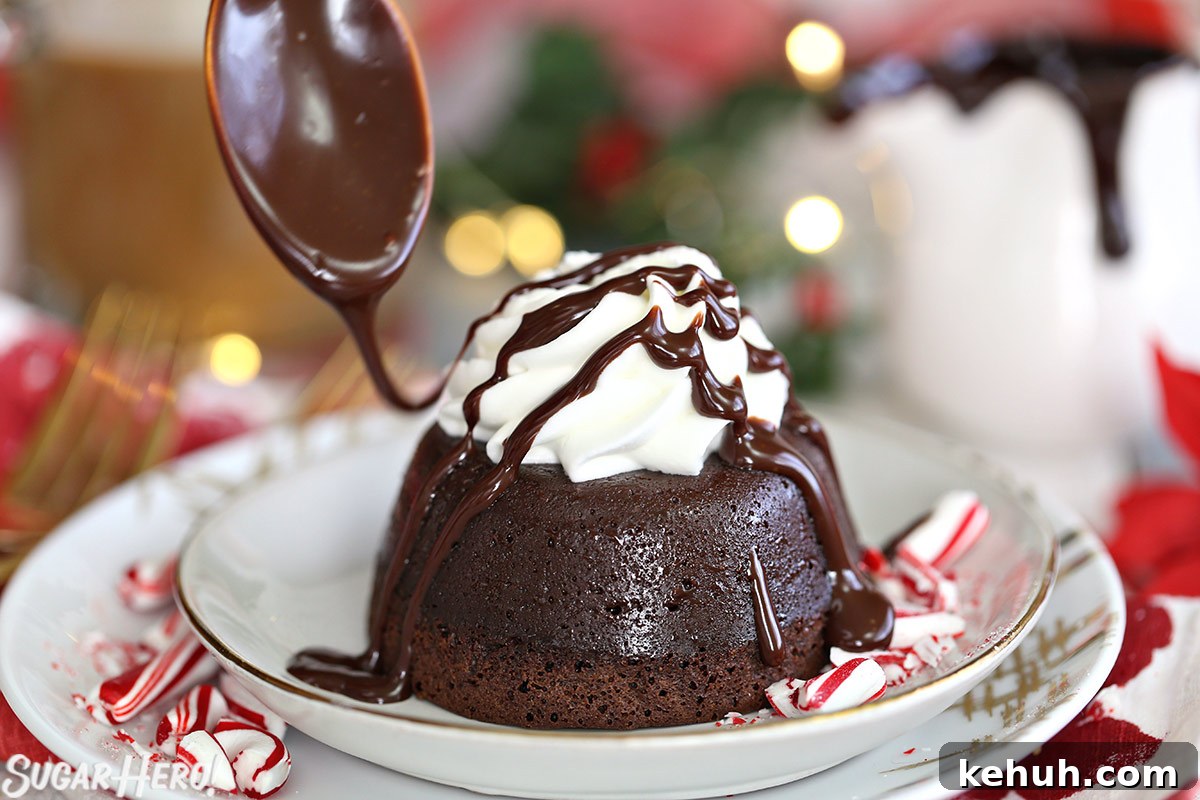 Spoon drizzling chocolate sauce over the top of a Peppermint Lava Cake.