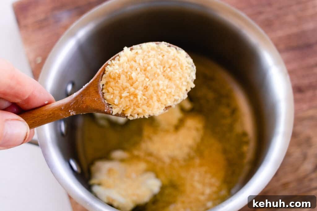 Adding candellila wax to the vegan lip balm recipe.