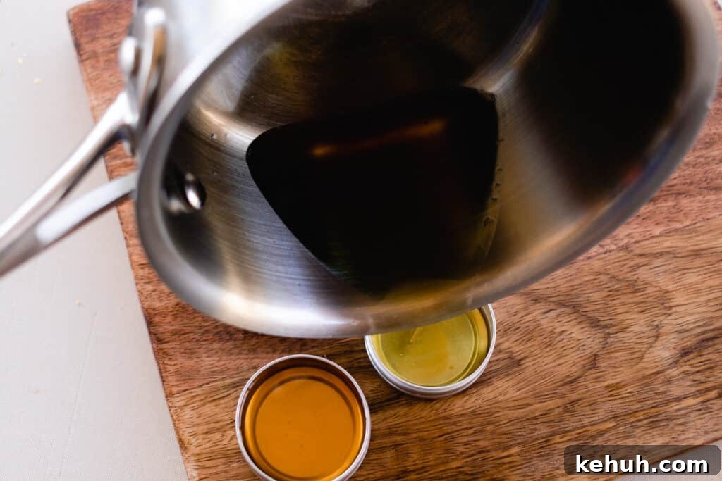 Pouring the melted ingredients from the saucepan into the small lip balm tins.