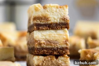 Salted Caramel Swirl Cheesecake Bars Recipe for Parties 12 Close up salted caramel cheesecake bars stacked