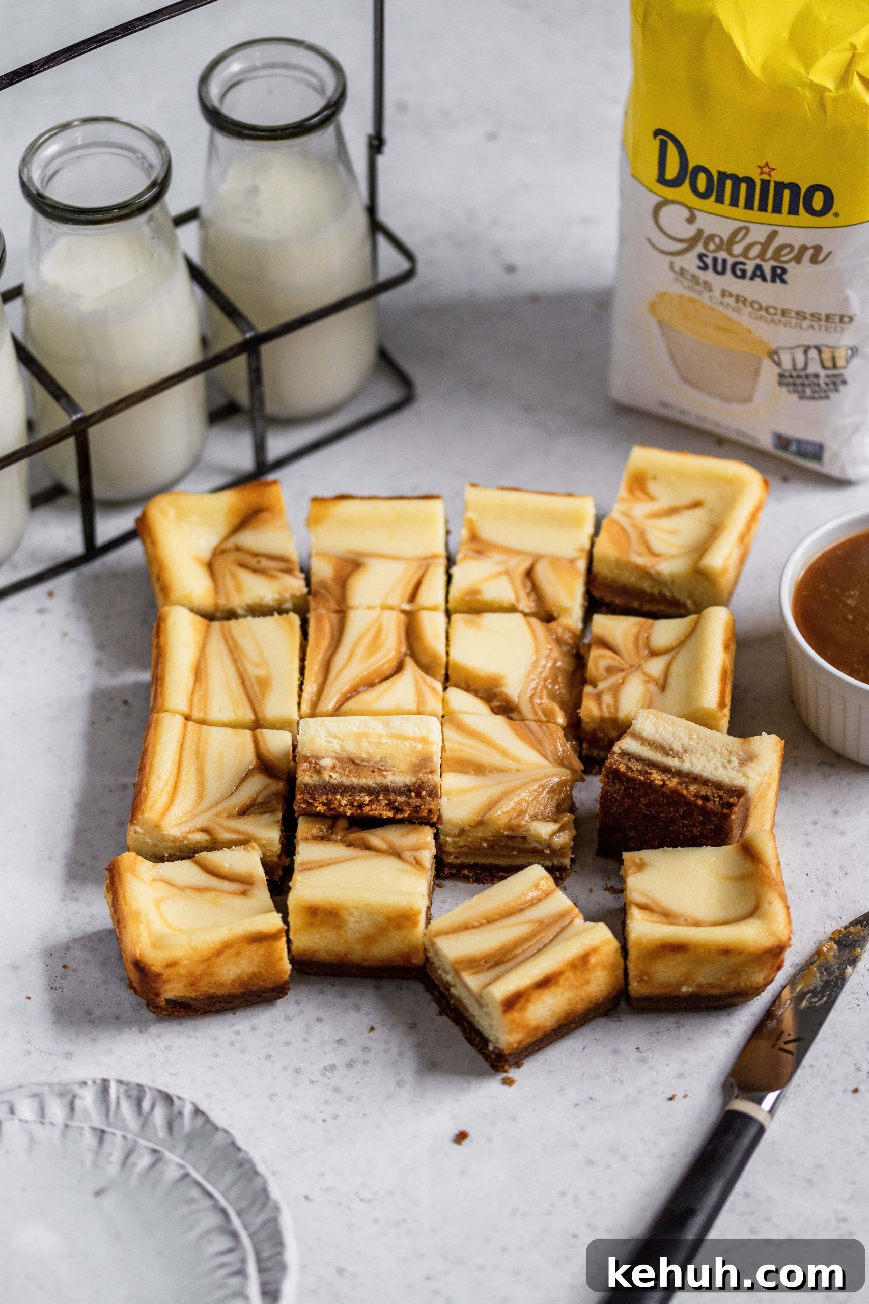 Salted Caramel Swirl Cheesecake Bars Recipe for Parties 7 Rearranged salted caramel swirl cheesecake bars with glasses of milk