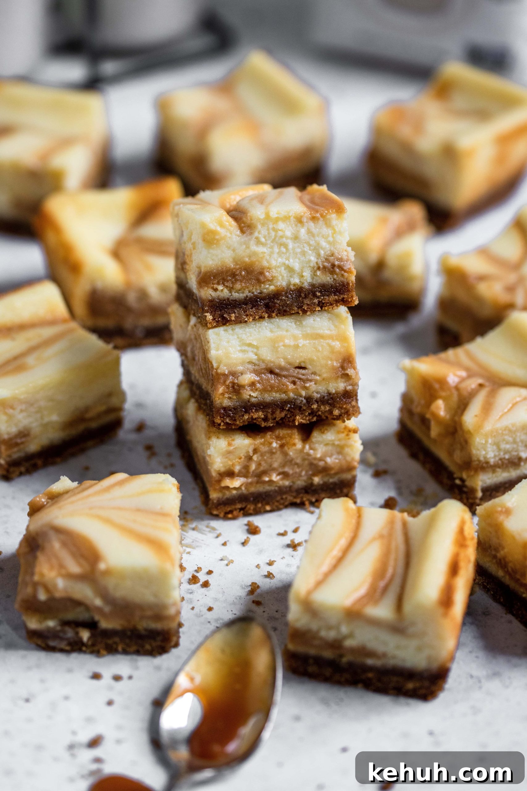 Salted Caramel Swirl Cheesecake Bars Recipe for Parties 8 Salted caramel swirl cheesecake bars stacked