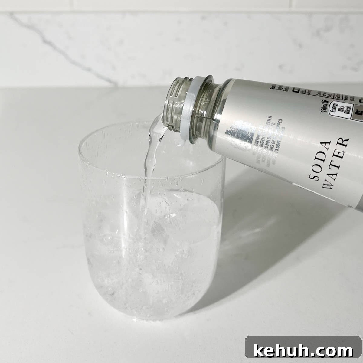 Classic Rock Shandy Recipe: Refreshing Lemon Beer Cocktail 5 Adding soda water to the glass.