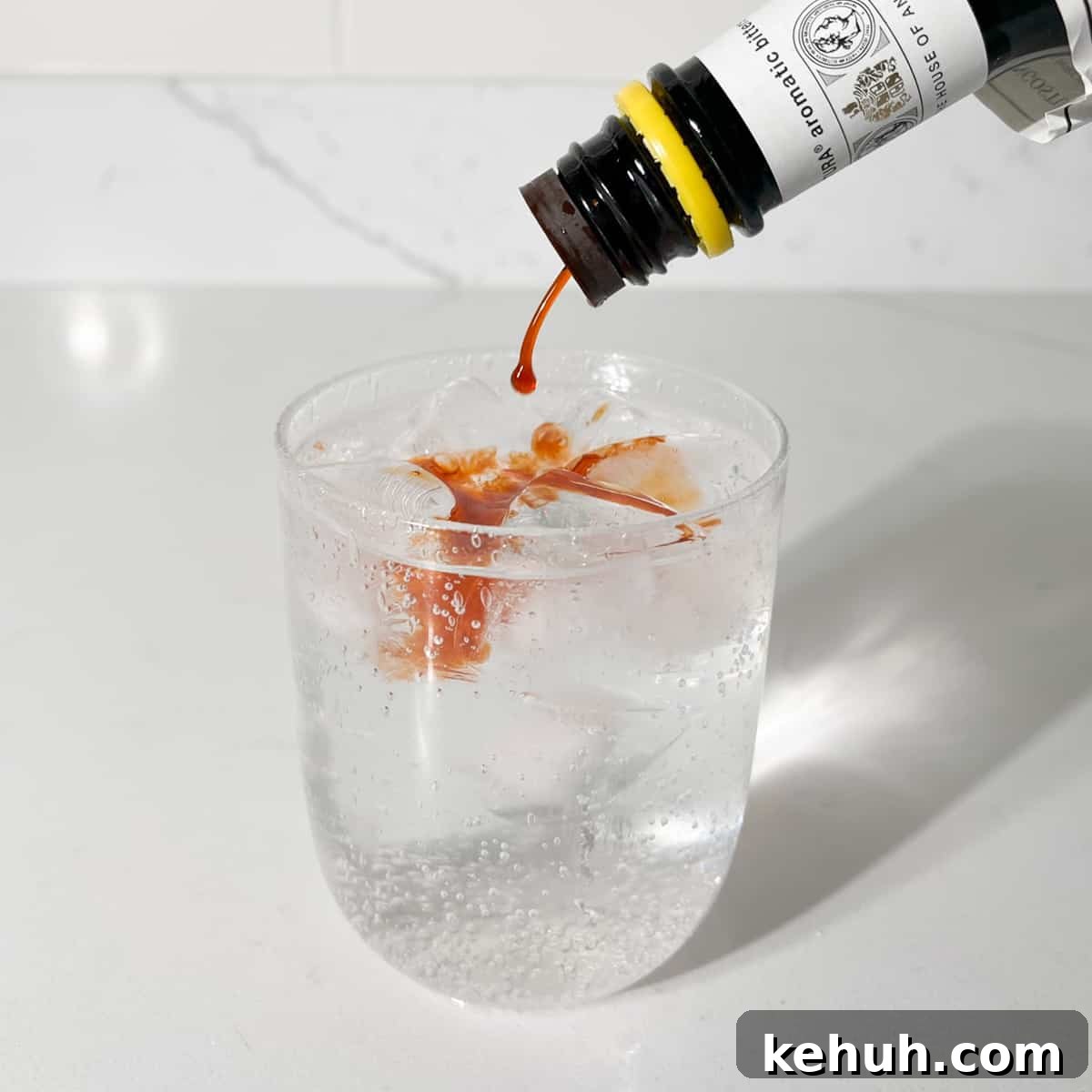 Classic Rock Shandy Recipe: Refreshing Lemon Beer Cocktail 6 Adding Angostura bitters to the rock shandy.