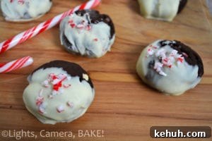 Peppermint Chocolate Christmas Cookies. Chocolate mint cookies with crushed candy canes and white chocolate chips. Dipped in white chocolate and topped with more candy canes! #candycanecookies #peppermintcookies #christmasbaking