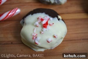 Peppermint Chocolate Christmas Cookies. Chocolate mint cookies with crushed candy canes and white chocolate chips. Dipped in white chocolate and topped with more candy canes! #candycanecookies #peppermintcookies #christmasbaking
