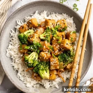 Overhead image of a plate of tempeh stir fry served over rice.