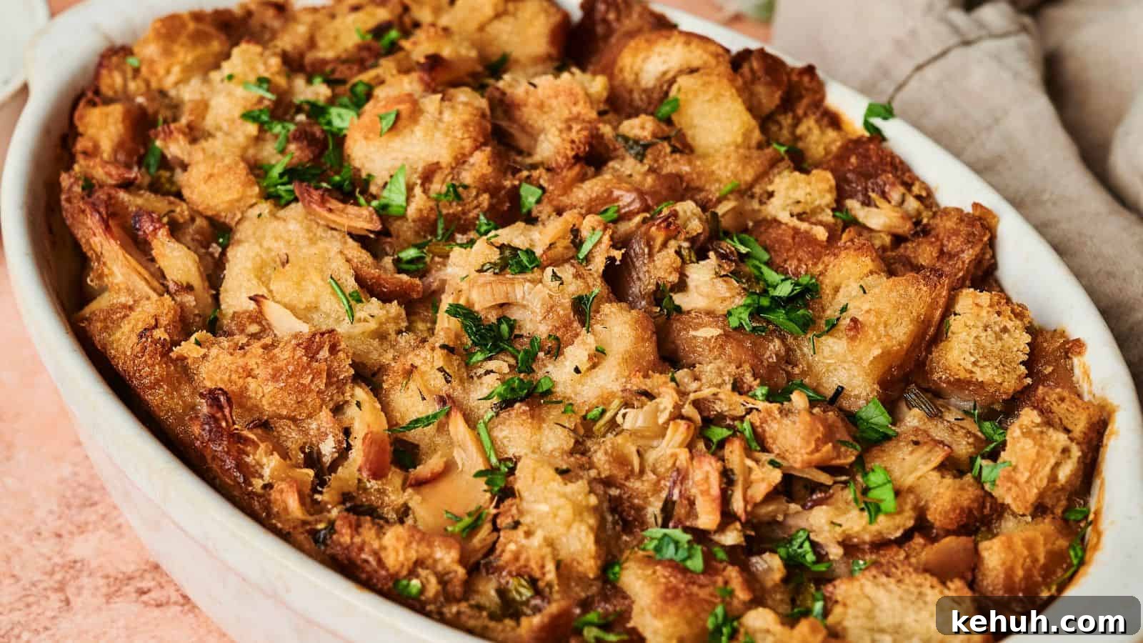 31 Homemade Thanksgiving Sides That Outshine Store-Bought 33 A golden brown Thanksgiving casserole of baked stuffing garnished with fresh herbs.