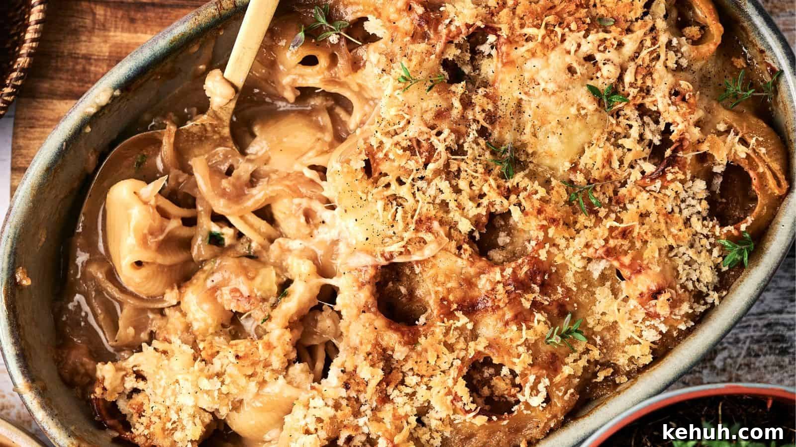 31 Homemade Thanksgiving Sides That Outshine Store-Bought 5 A baked casserole dish filled with creamy macaroni and cheese, topped with a golden-brown breadcrumb crust and garnished with fresh herbs.
