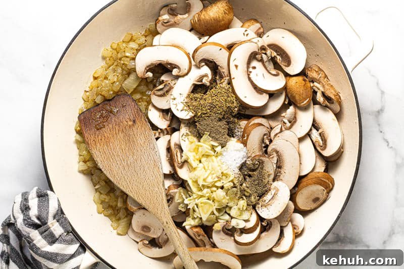 Vegan Mushroom Stroganoff Without Cashew Cream or Roux 6 Large white pan with sauteed onion sliced mushroom fresh garlic and herbs