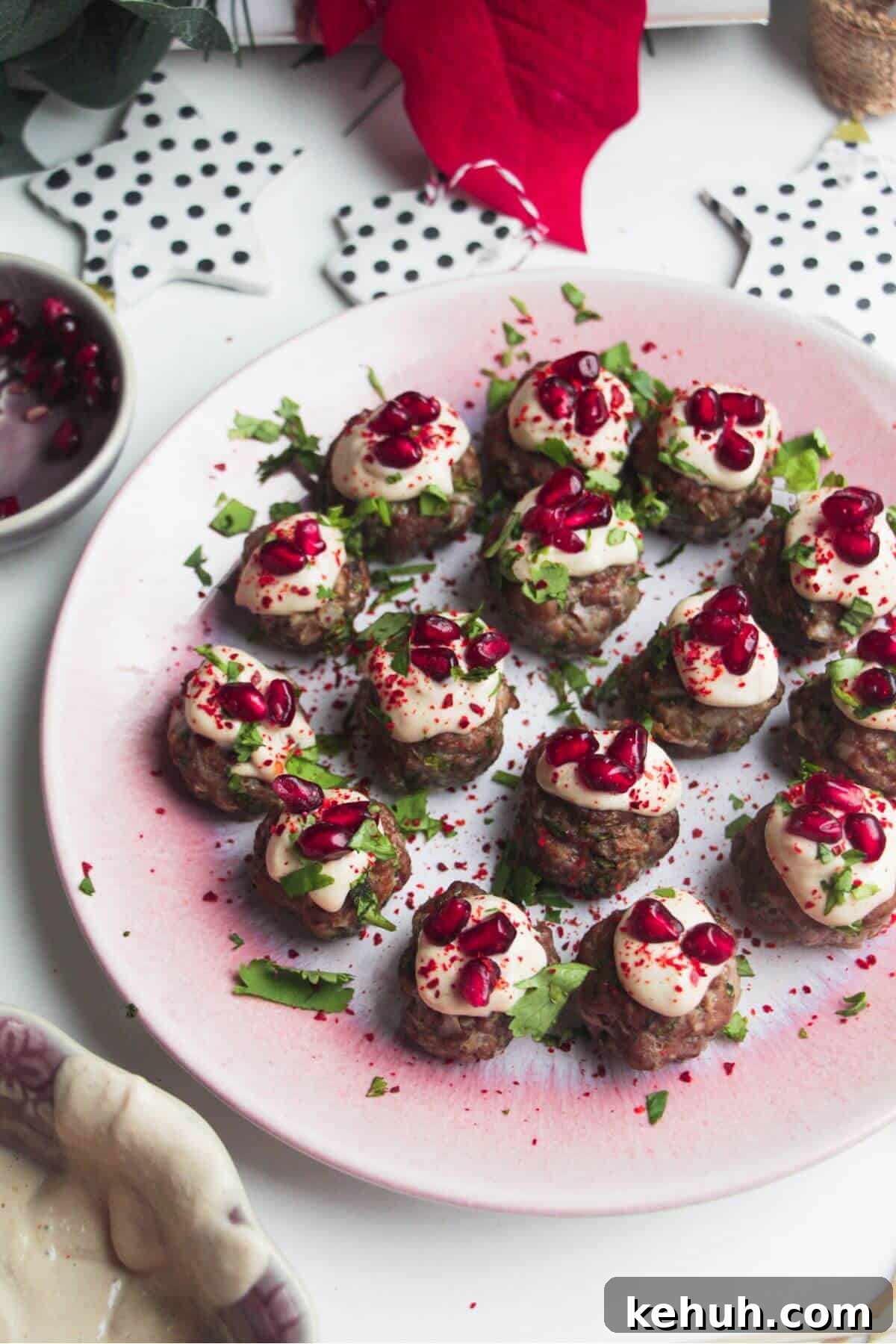 Festive Mini Meatballs Recipe for Holiday Appetizers 2 Decorated lamb meatballs on a small pink plate.