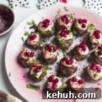 Decorated lamb meatballs on a small pink plate.