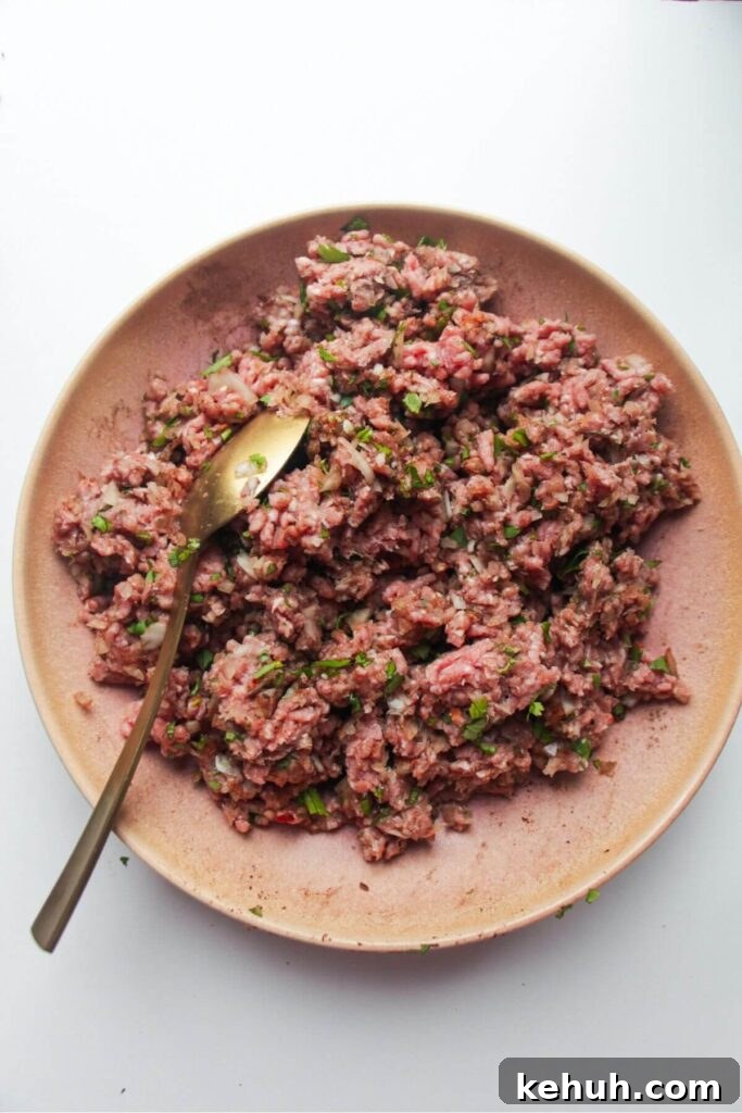 Festive Mini Meatballs Recipe for Holiday Appetizers 5 Meatball ingredients mixed in a pink bowl.