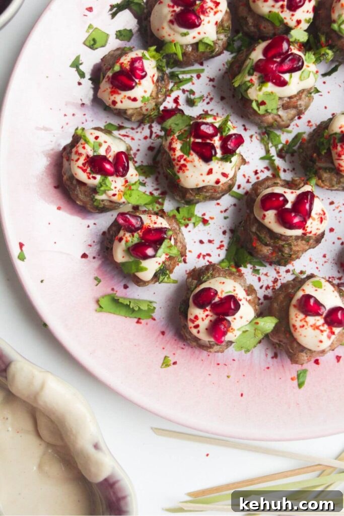 Festive Mini Meatballs Recipe for Holiday Appetizers 9 Close up of decorated lamb meatballs on a small pink plate.