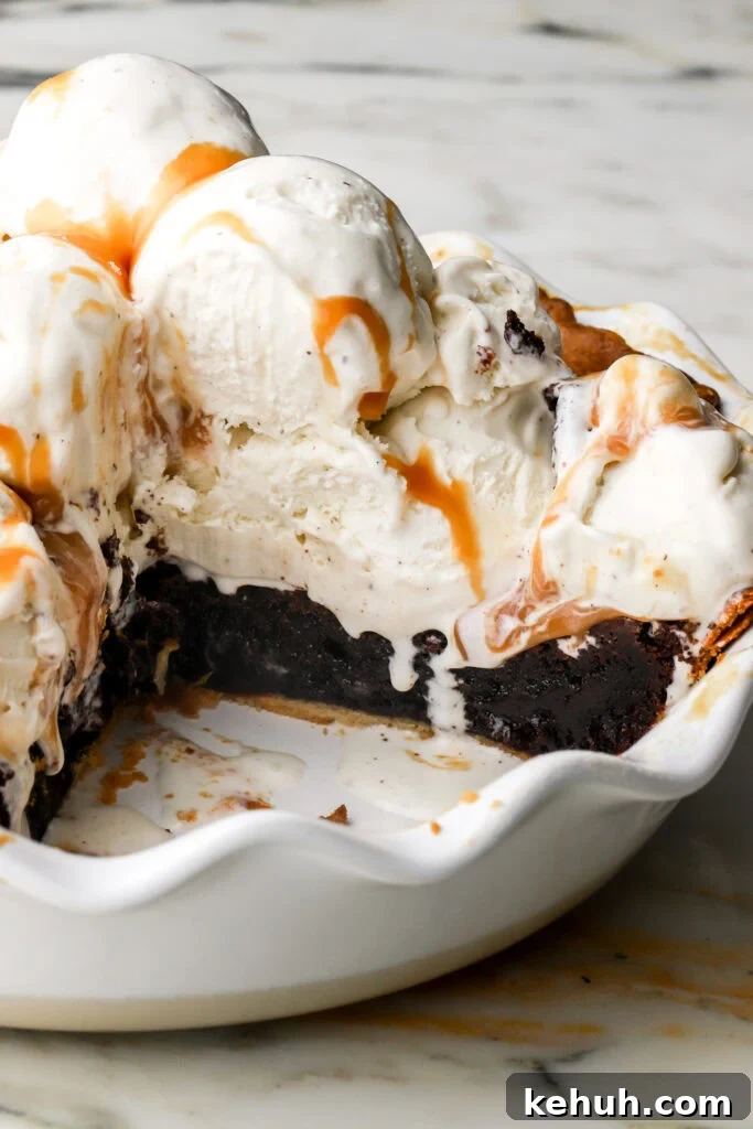 Decadent Chocolate Brownie Pie Recipe for Chocolate Lovers 2 brownie pie in pie dish topped with vanilla ice cream