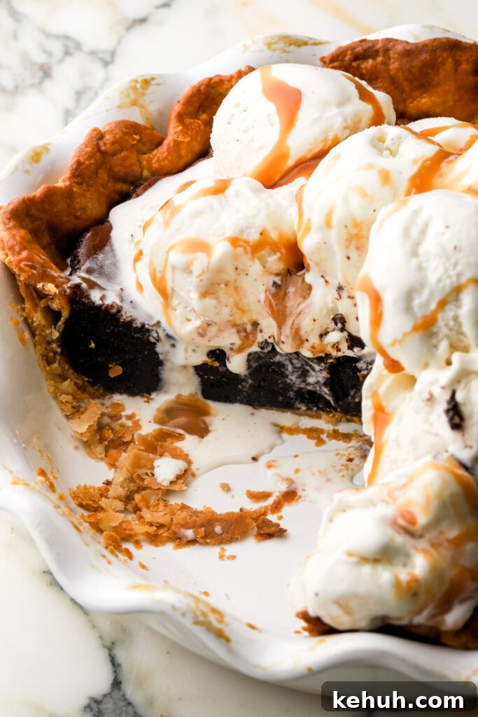 Decadent Chocolate Brownie Pie Recipe for Chocolate Lovers 20 brownie pie in pie dish topped with vanilla ice cream