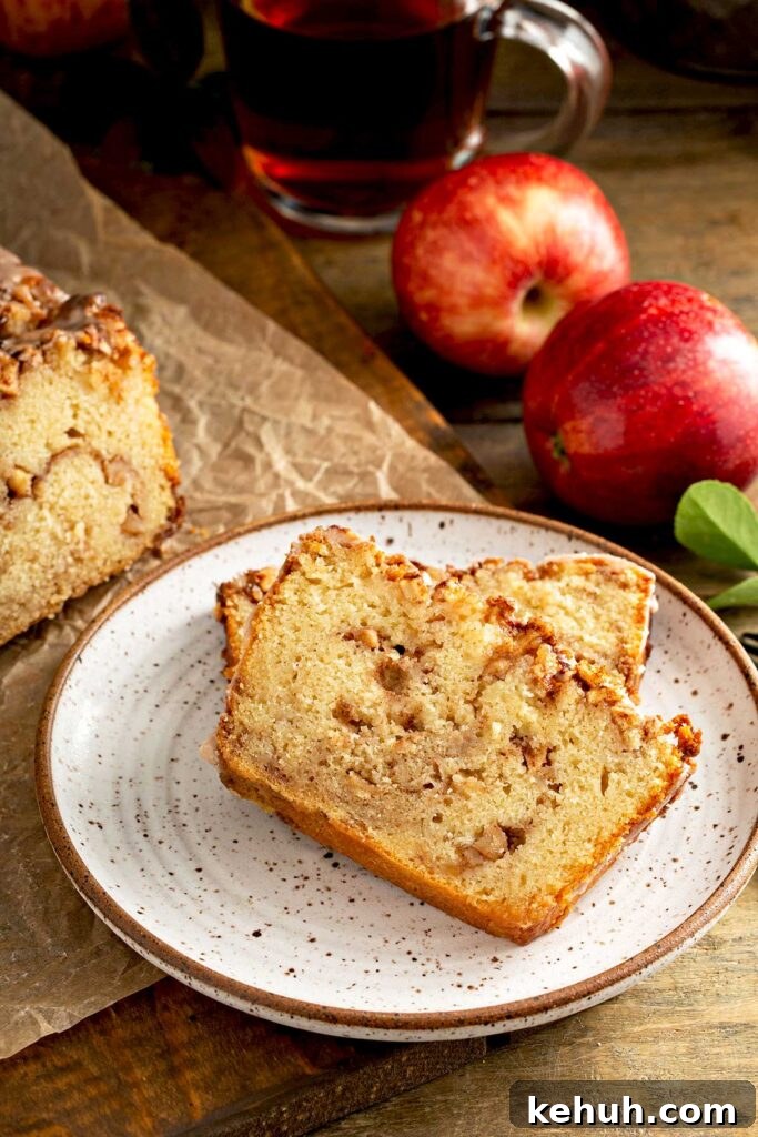 Cinnamon Apple Quick Bread Recipe for Moist, Spiced Loaves 8 Two slices of apple bread on a white plate