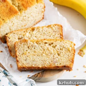 Moist Buttermilk Banana Bread with Brown Sugar Glaze 14 Two slices of banana bread next to the loaf with a banana on the side.