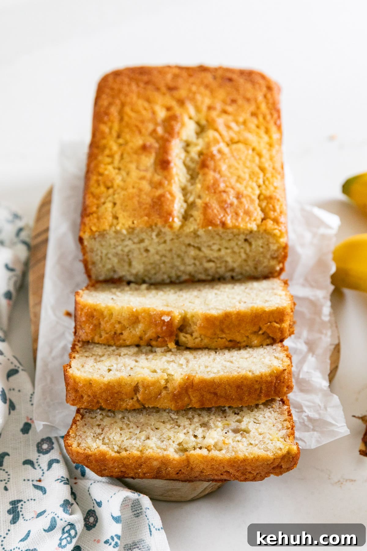Moist Buttermilk Banana Bread with Brown Sugar Glaze 9 A loaf of banana bread with 3 slices next to it.