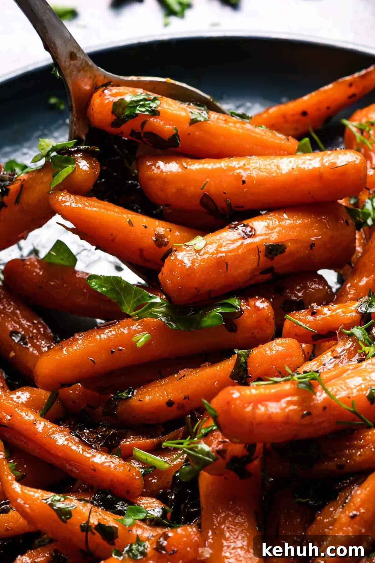 honey orange glazed carrots on plate with spoon