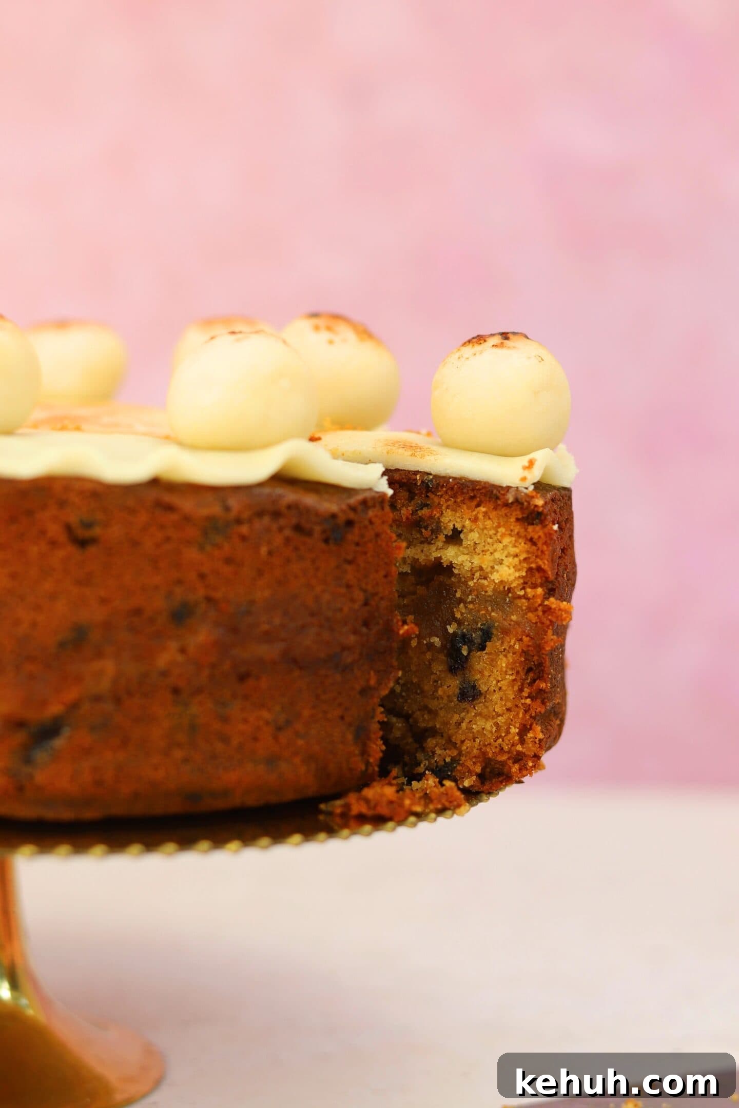 Gluten-Free Simnel Cake Recipe: Traditional Easter Fruit Cake 10 A gluten free simnel cake with a slice cut from it, showing the marzipan centre.