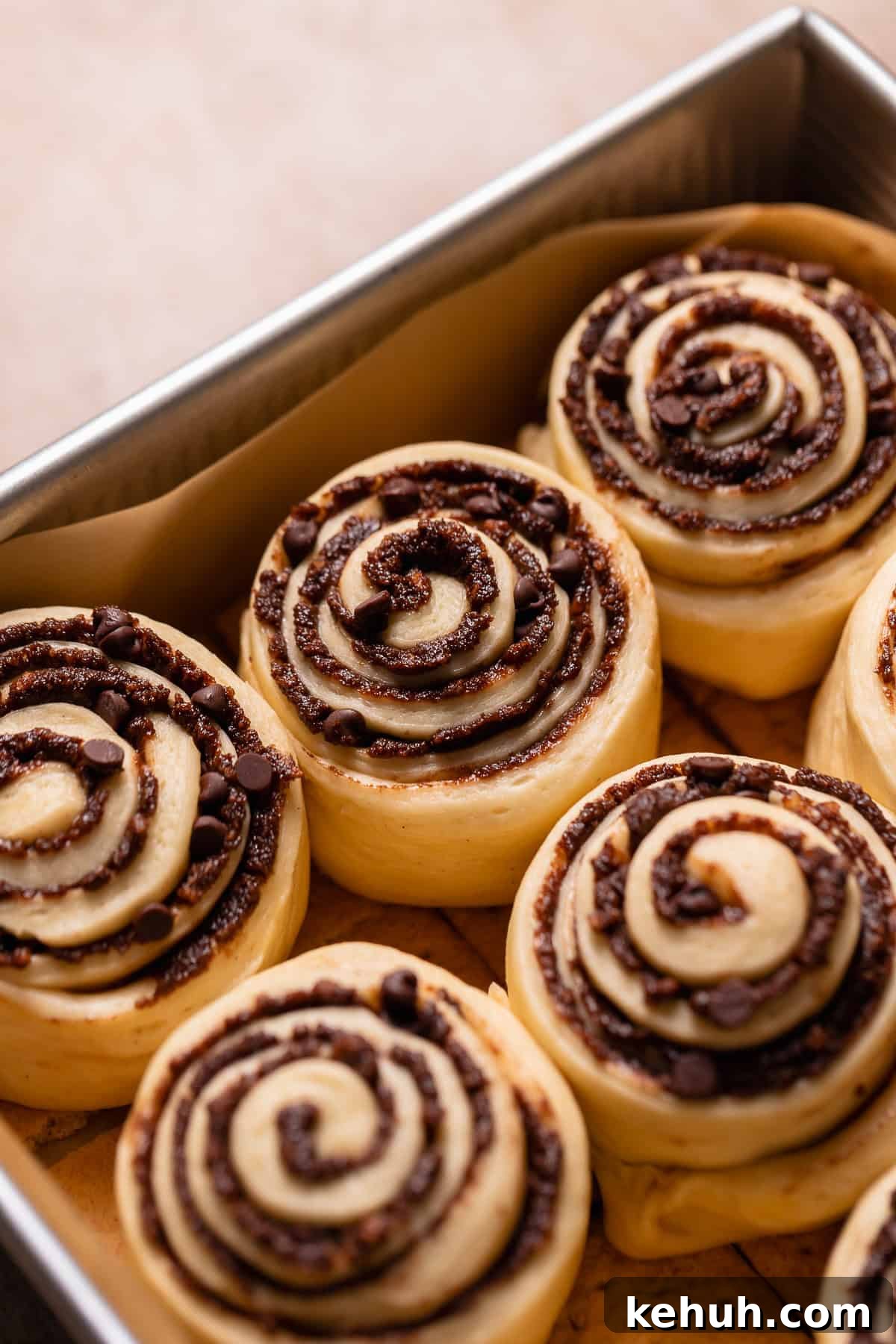 Cinnamon rolls in a baking pan showing they have doubled in size.