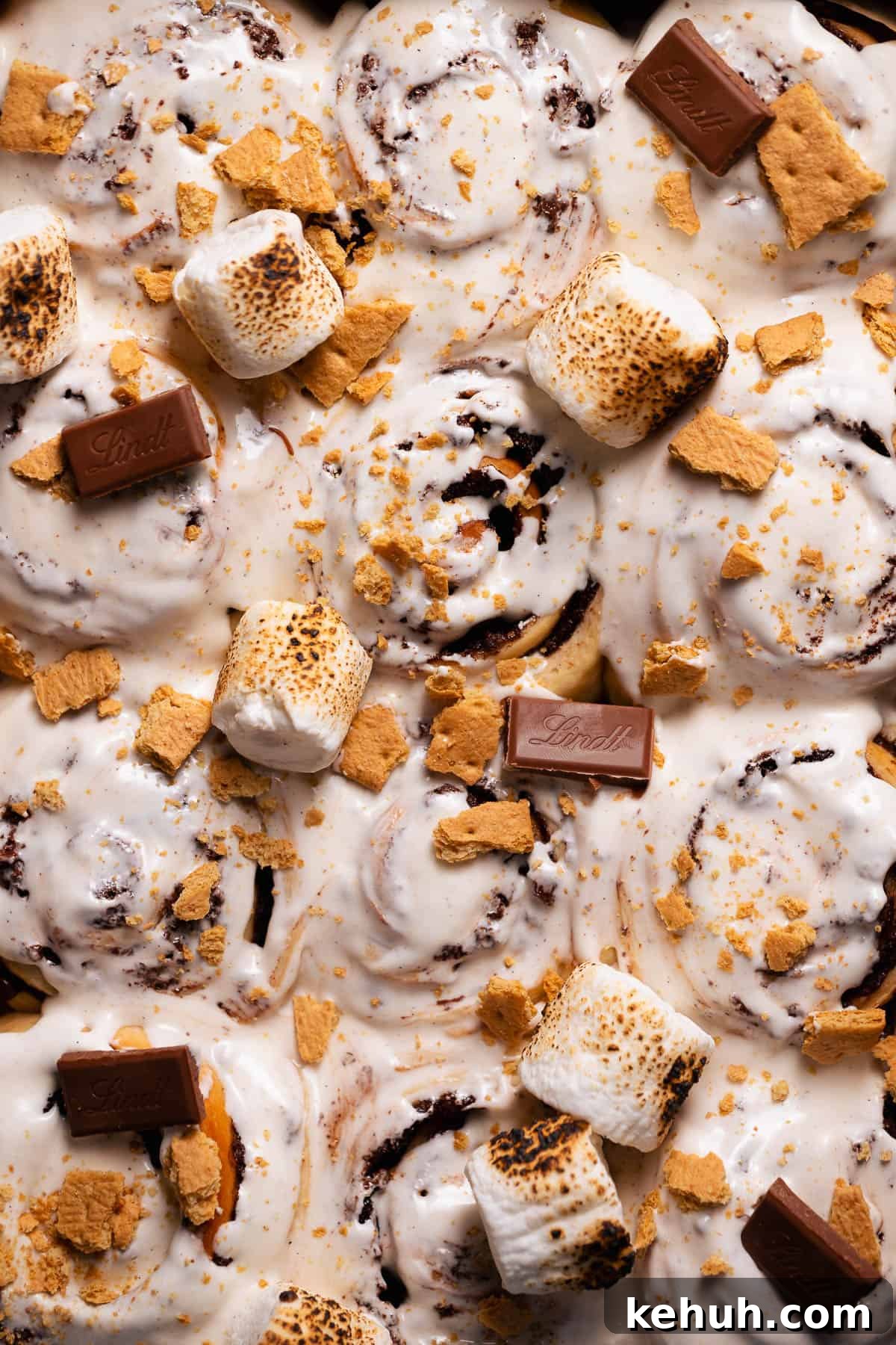 An overhead shot of the smores rolls topped with marshmallow glaze and toasted marshmallows.