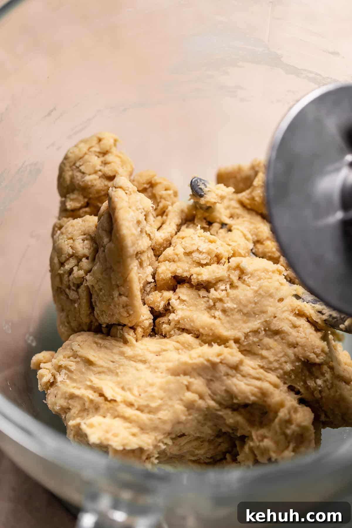 Rough dough ball in a glass mixing bowl.