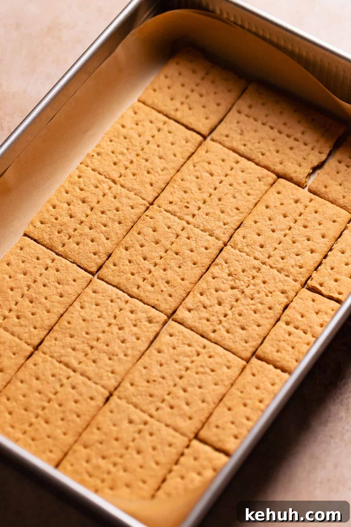 A sheet pan with graham crackers lining the bottom of it.