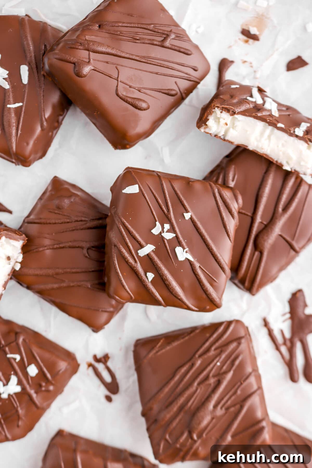 Coconut Cream-Filled Chocolate Truffles: Decadent Homemade Recipe 3 close up of square chocolates on parchment paper with one cut open