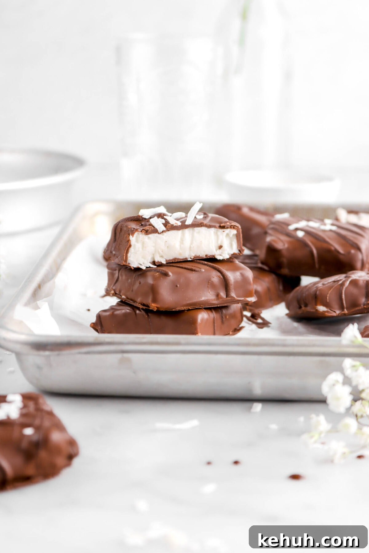 Coconut Cream-Filled Chocolate Truffles: Decadent Homemade Recipe 4 stacked coconut chocolates in sheet pan with top chocolate cut open