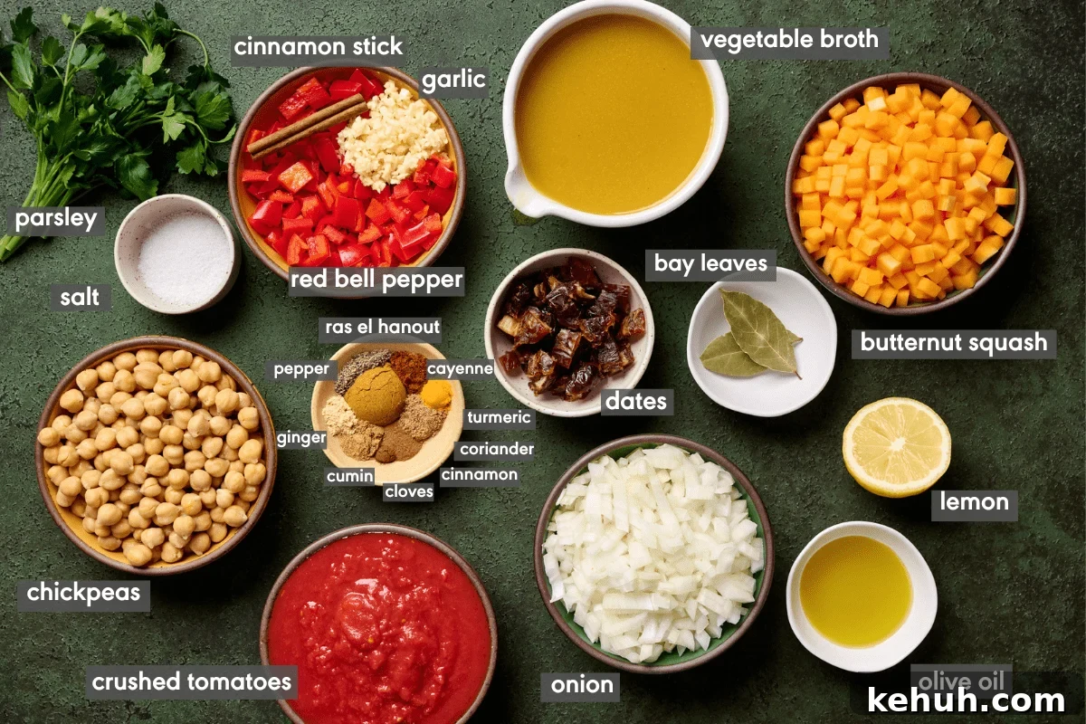 ingredients for vegan tagine with chickpeas in individual bowls on a green surface with ingredients labeled.