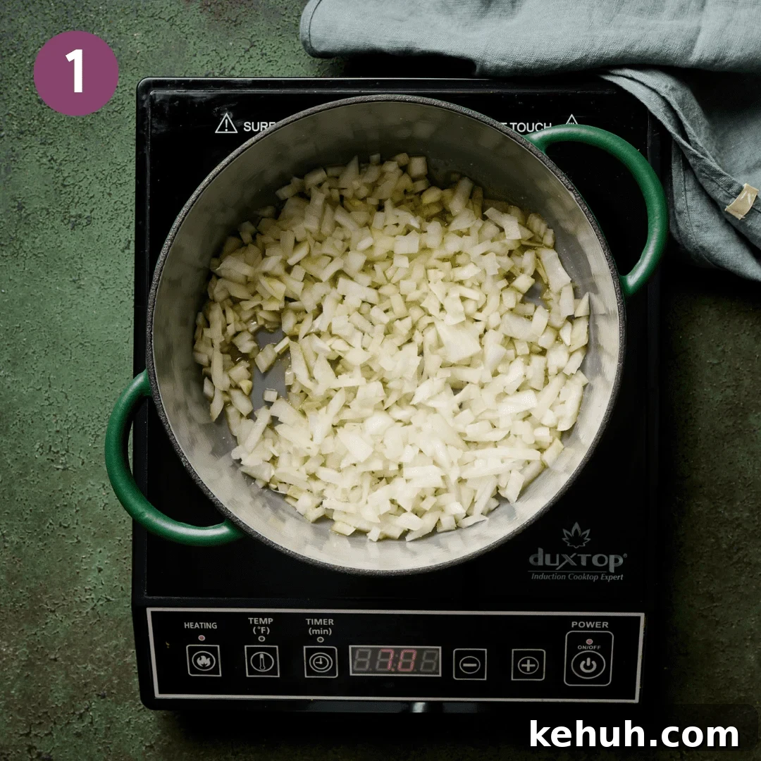 Onion and olive oil cooking in a dutch oven.