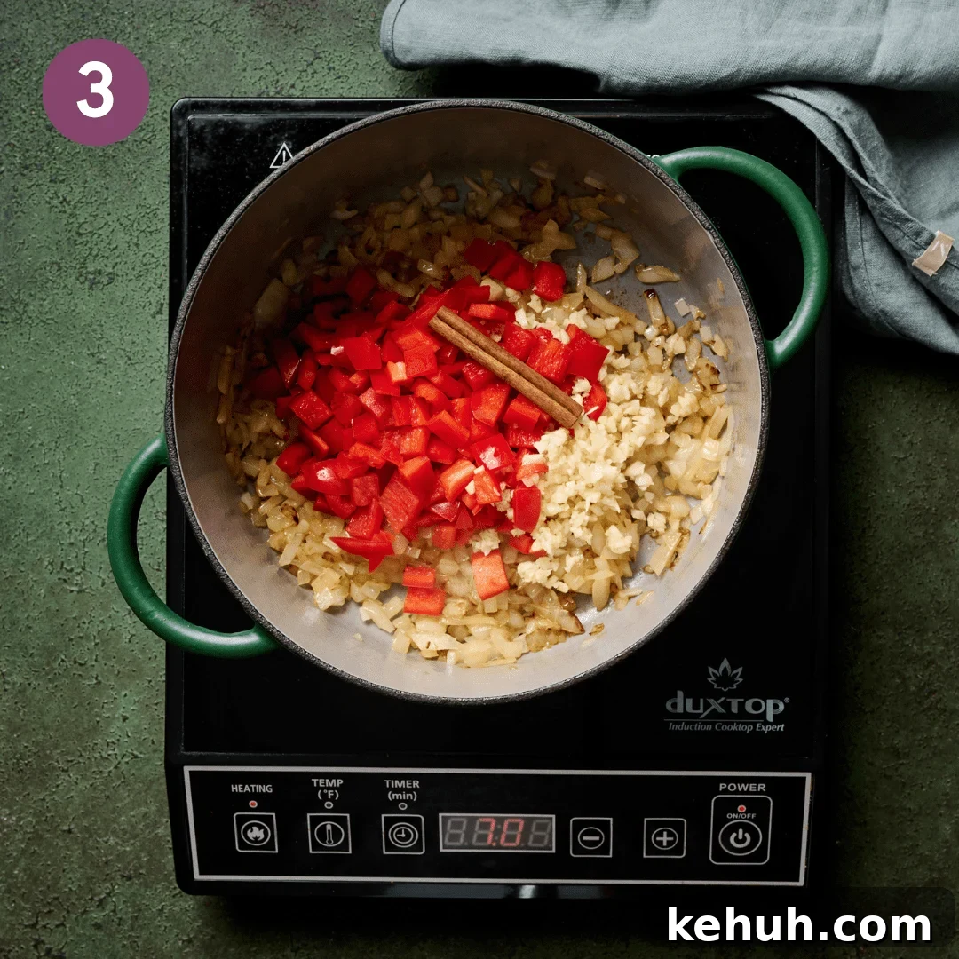 Garlic, bell pepper and cinnamon stick with the onions in the dutch oven.