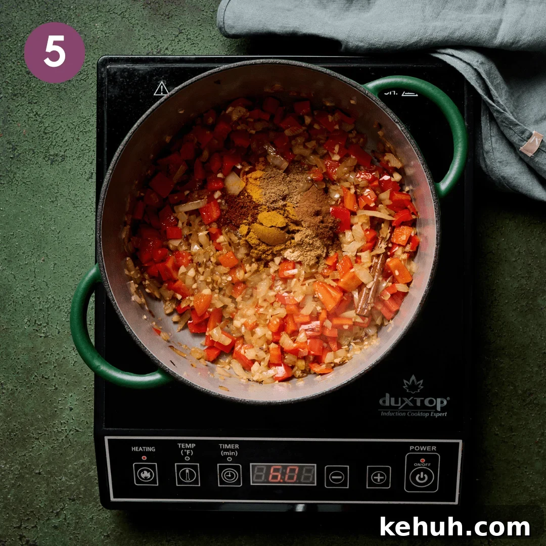 All the spices added on top of the other ingredients in the pot.
