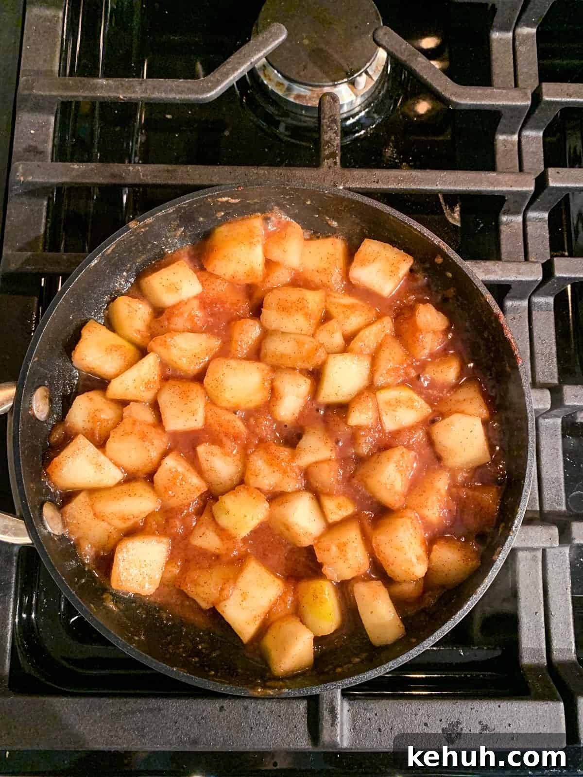 Stovetop Cinnamon Apples Recipe — Quick Comfort Dessert 7 Diced apples simmering with cinnamon and maple syrup.