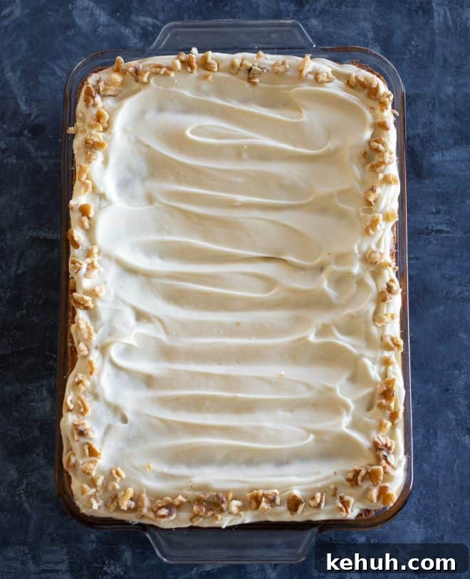 Classic Moist Carrot Cake Recipe with Cream Cheese Frosting 4 carrot cake in a baking dish with walnuts