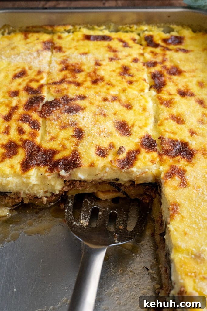 Moussaka in a stainless steel pan.