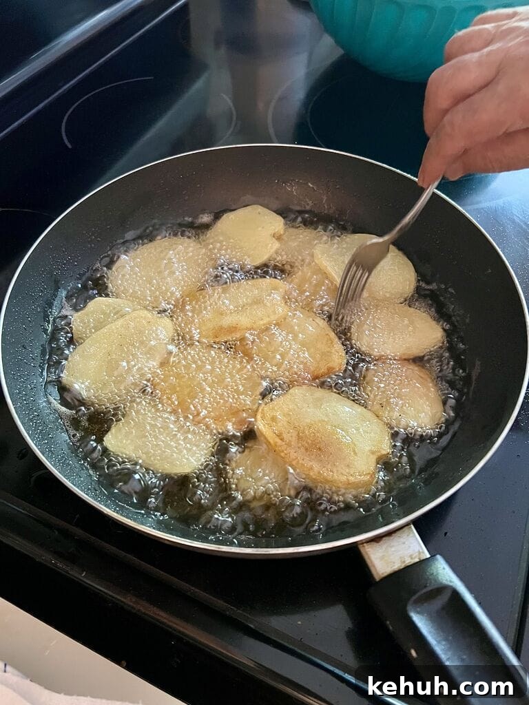 Frying the potatoes.