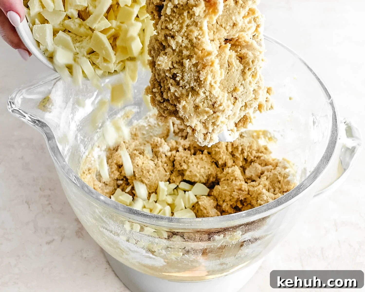 Add the white chocolate chunks into the cookie dough.