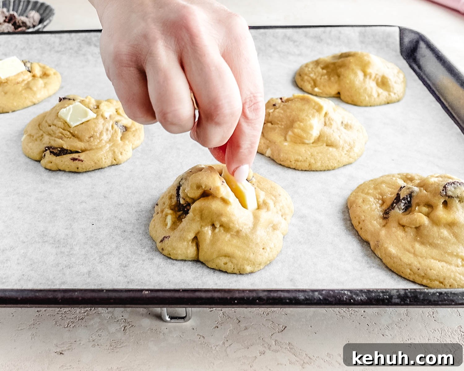 Halfway through baking, top each cookie with a piece of white chocolate and a dried strawberry.