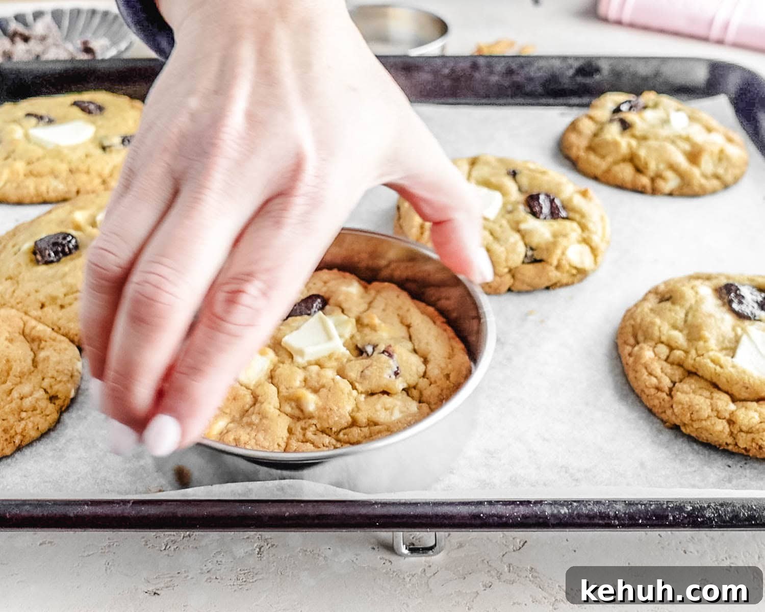 Use a large round cookie cutter to scoot the edges of the cookies in to create perfectly round, thick cookies.