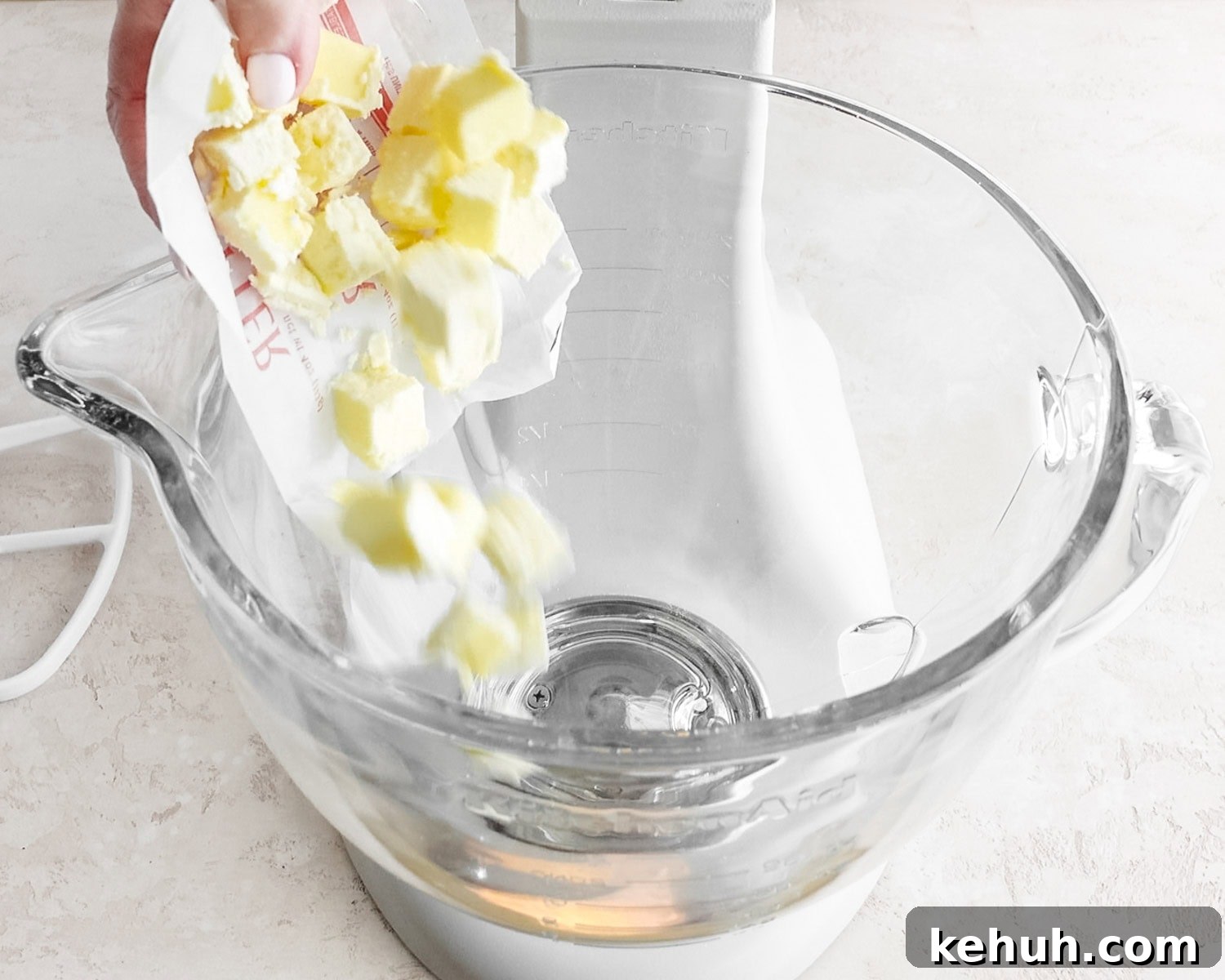 Add cold cubed butter to the bowl of a stand mixer.