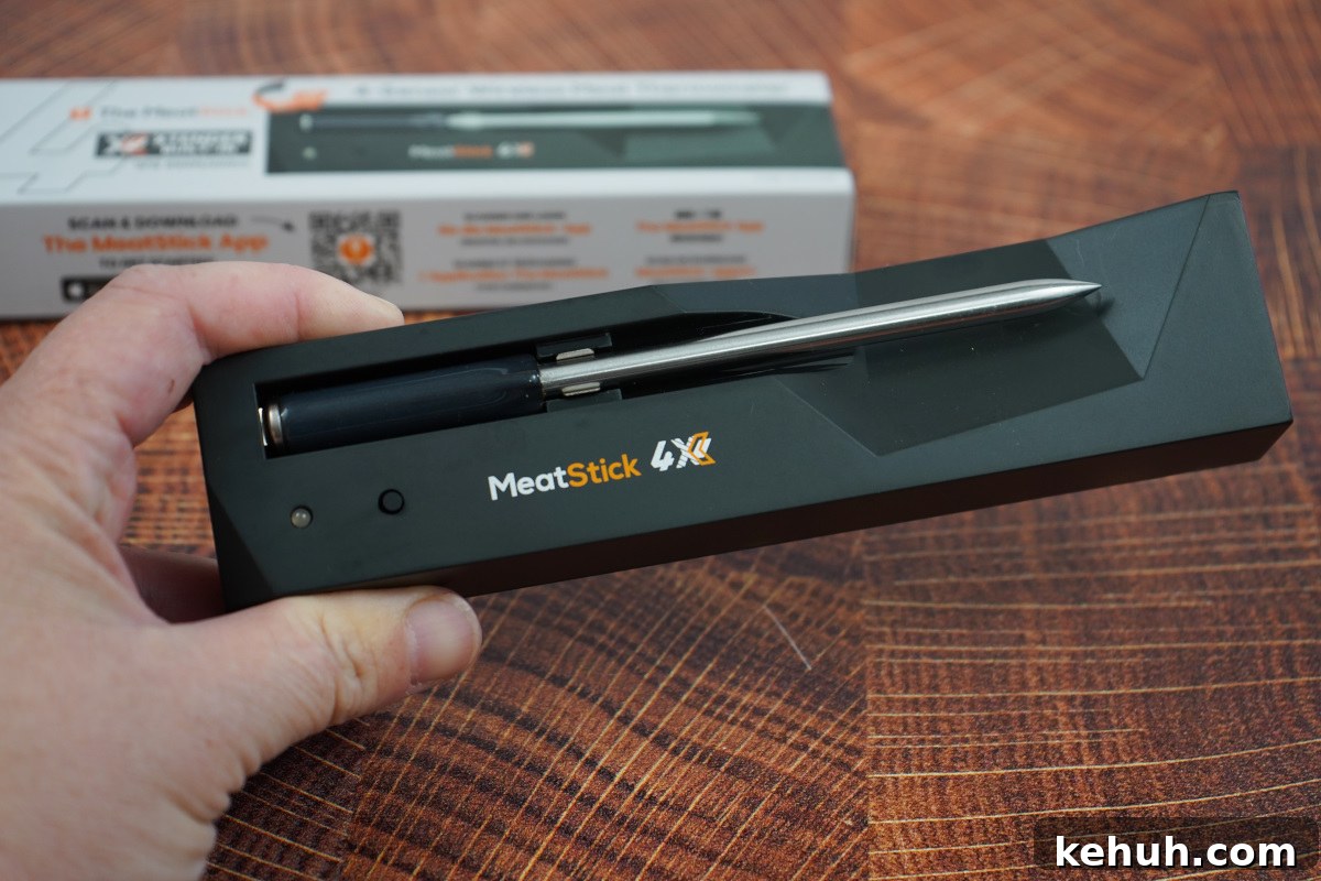 The Meatstick in charging block with box behind it. 