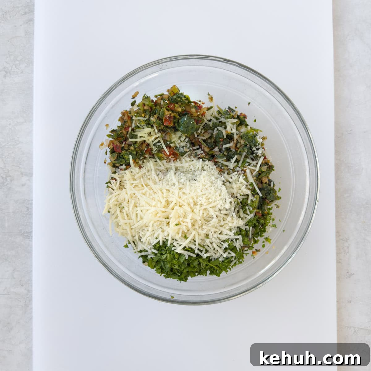 Parmesan Spinach-Stuffed Mushrooms: Savory Appetizer Recipe 12 Bowl of cooked stuffing with spinach, sun-dried tomatoes, and parmesan.