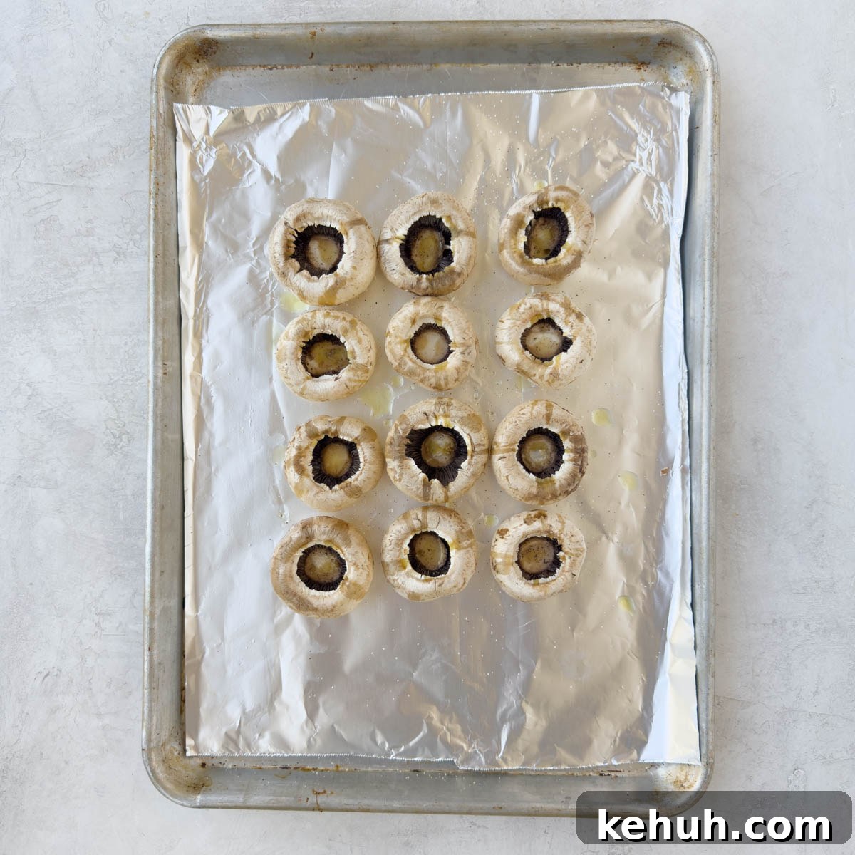 Parmesan Spinach-Stuffed Mushrooms: Savory Appetizer Recipe 7 Large mushroom caps on a foil lined baking sheet.